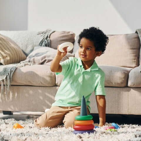 Black kid playing with toys.