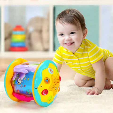 Baby crawling towards a rotating music toy which features lights, sounds, dolphin, and a turtle.