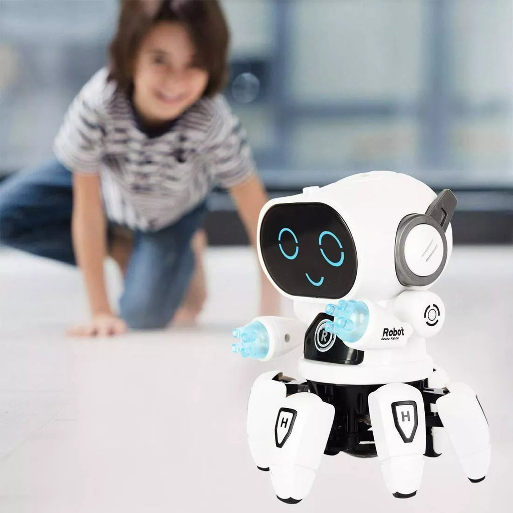 A white and black interactive BoogieBot 3000 robot toy with glowing blue LED hands and a smiling digital face, standing on a clean floor. In the background, a young child in a striped shirt and jeans excitedly watches the robot while kneeling.