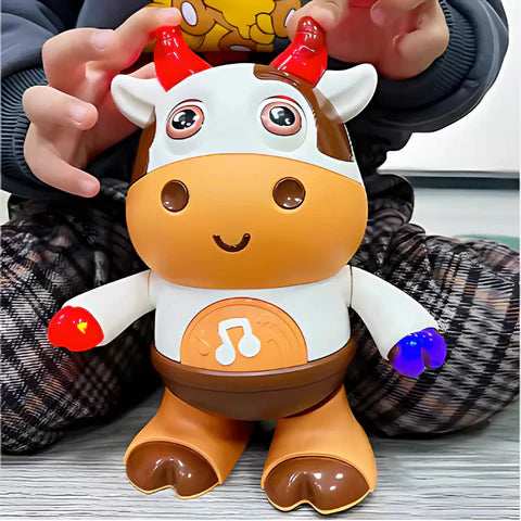 Child playing with a dancing cow musical toy.