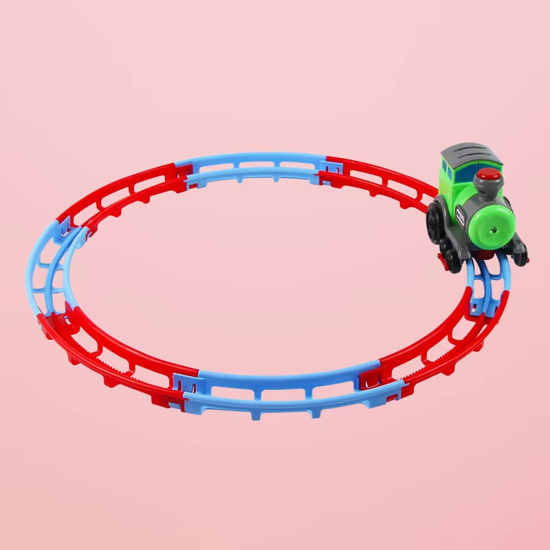 Green toy train circling around red and blue round rails. 