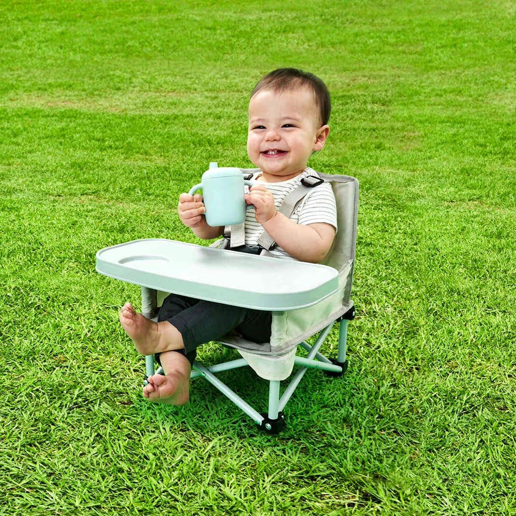 Baby boy smiling in his GoSit Junior chair.