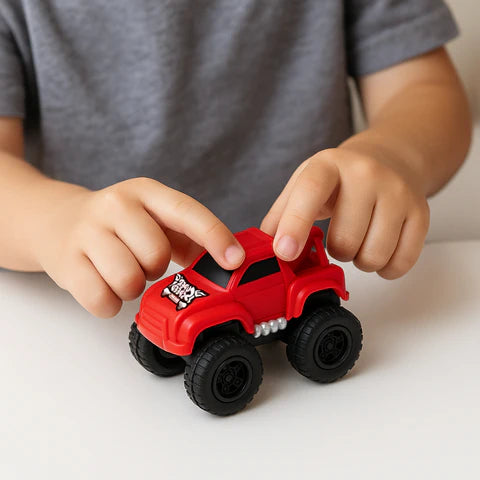 Boy holding his red truck featured in a 5-piece Magnetic Racers set. 