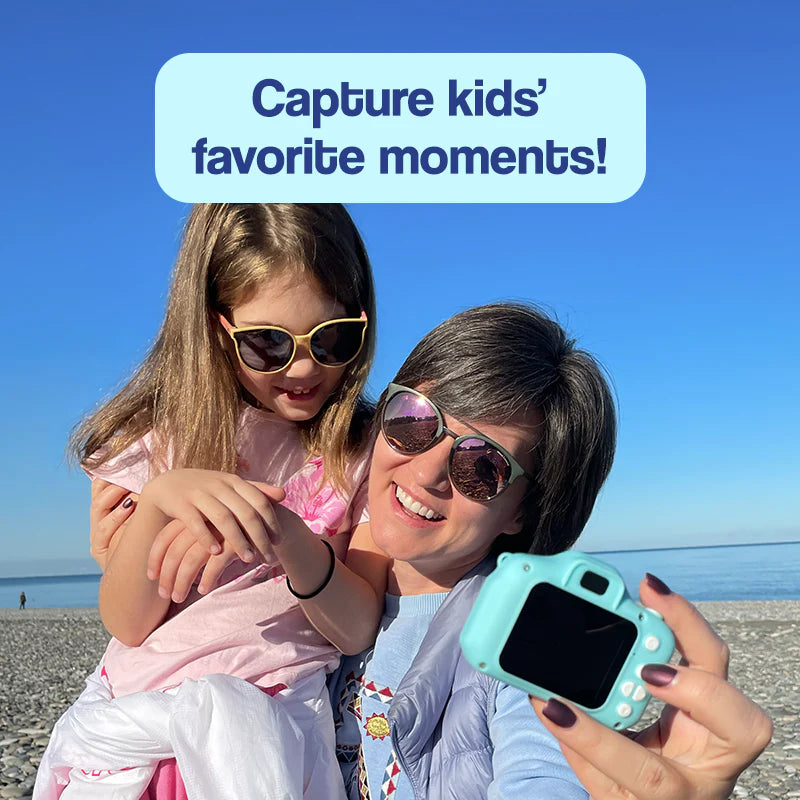 Mother and daughter taking a selfie at the beach with My First Camera toy. 