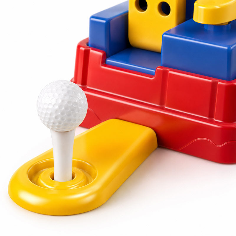 Close-up of an automatic golf tee on a Junior Golf Coach toy, holding a golf ball ready for the next swing.